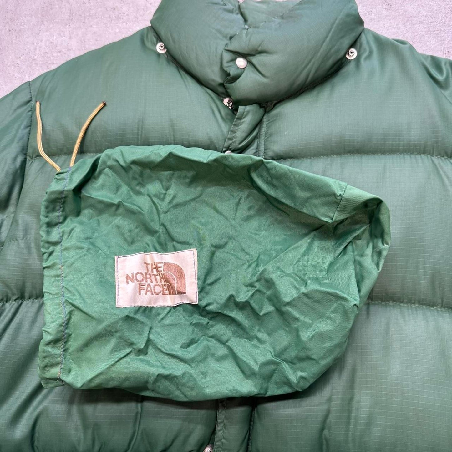 Green puffer jacket with adjustable